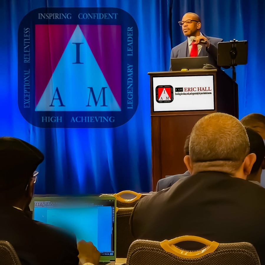 Eric Hall speaking on stage